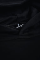 Close-up of a black fabric with 'Relique' branding.